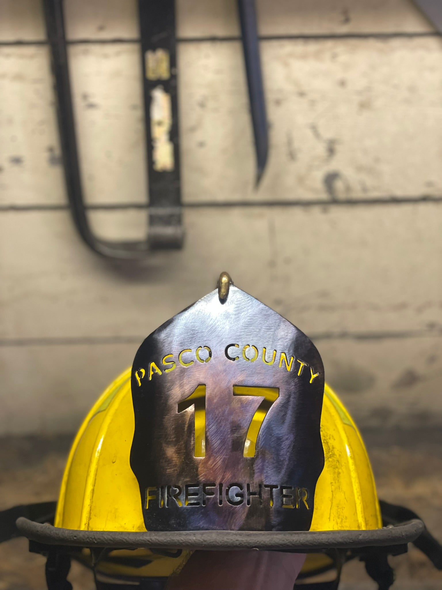 "Custom traditional torch patina metal firefighter helmet shield mounted on a Paul Conway traditional helmet, featuring personalized engravings with department name, unit number, and firefighter name, ideal for professional firefighting gear."
