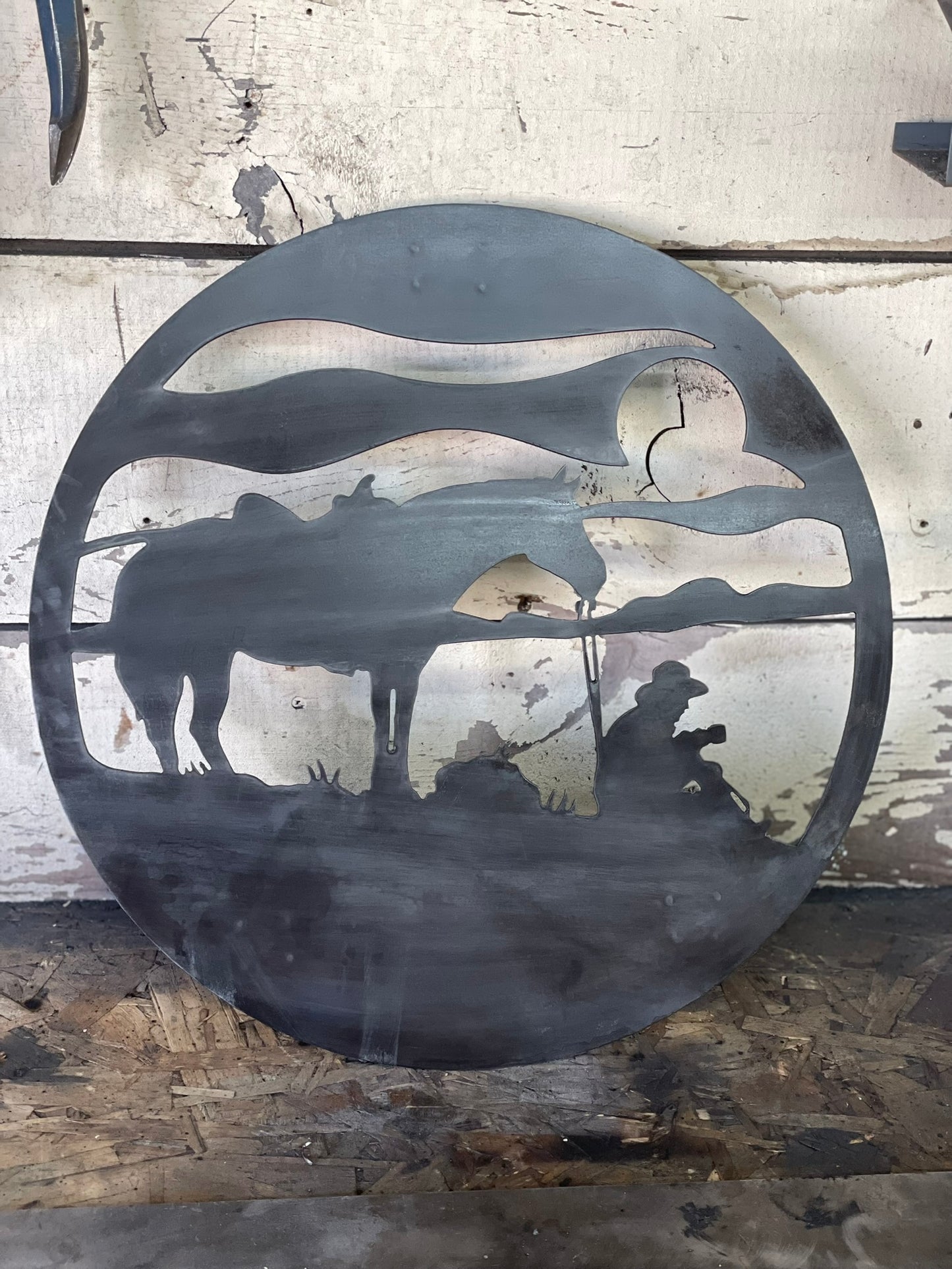 "Metal sign of a cowboy drinking coffee with a sunrise background, western themed decor with rustic, vintage style for home or ranch, perfect for country lovers."